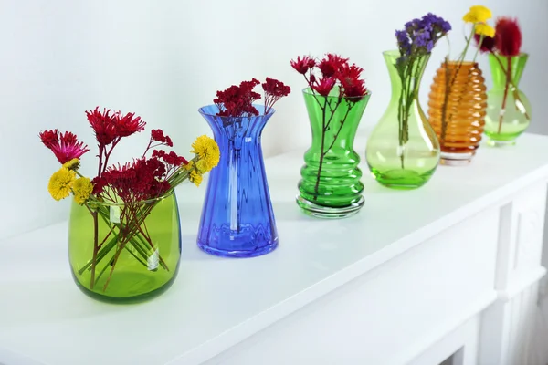 Colorful vases on white table, close-up — Stock Photo, Image