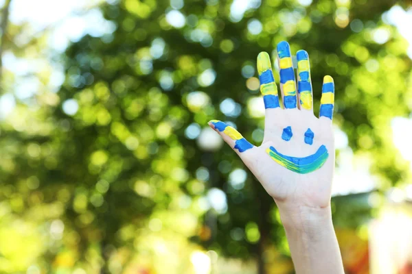 Smiling colorful hand on natural background — Stock Photo, Image