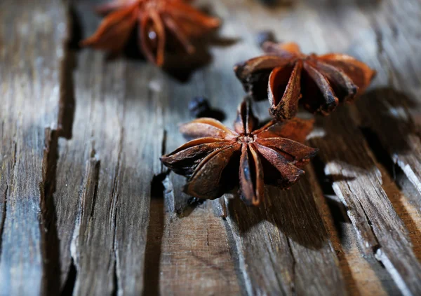 Star anise on dark wood — Stock Photo, Image