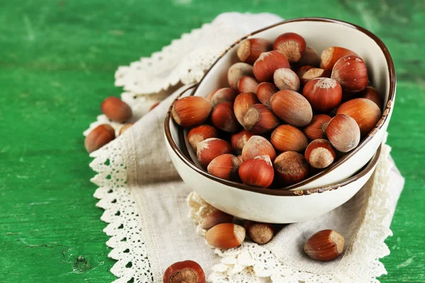 Hazelnuts on plate on napkin — Stock Photo, Image