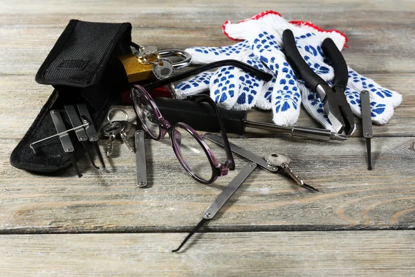 Tools of picking locks on wooden table — Stock Photo, Image