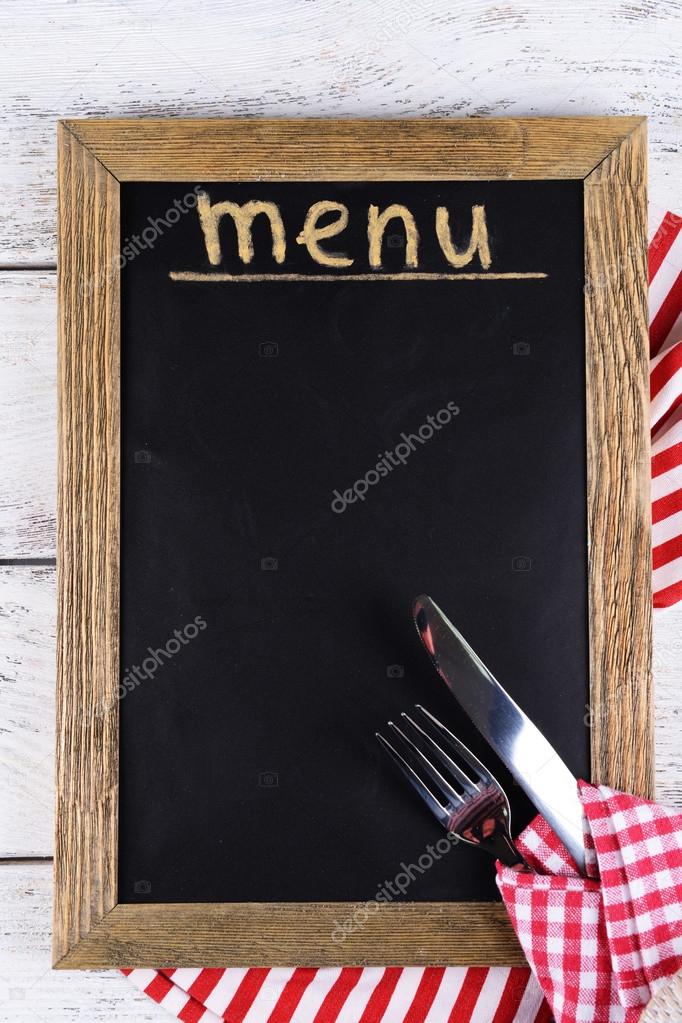 Inscription menu on chalkboard on table close-up