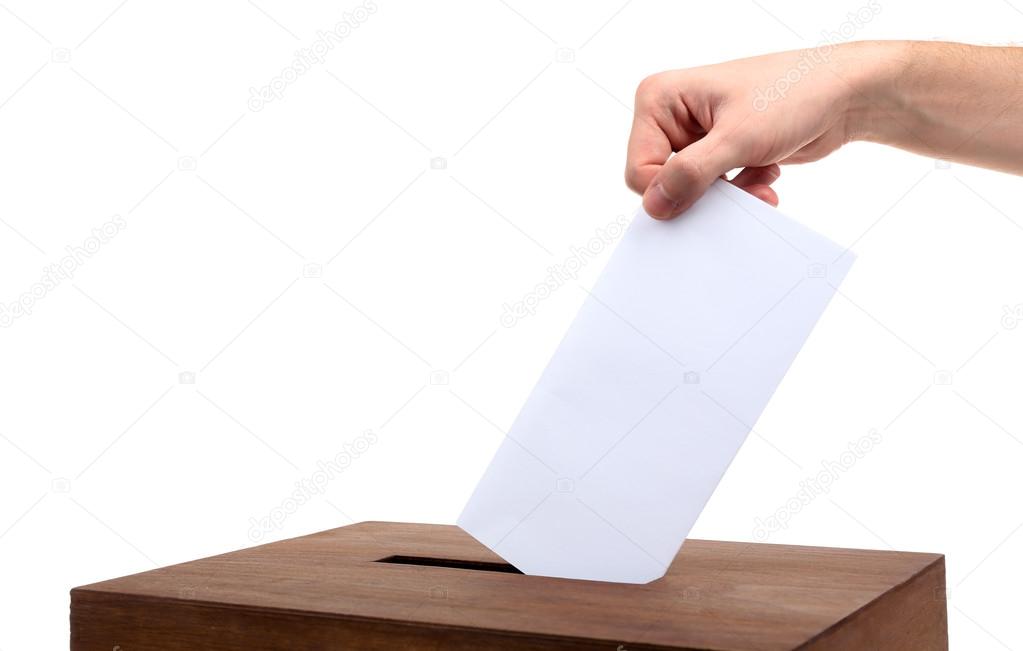 Human hand inserting envelope in mailbox