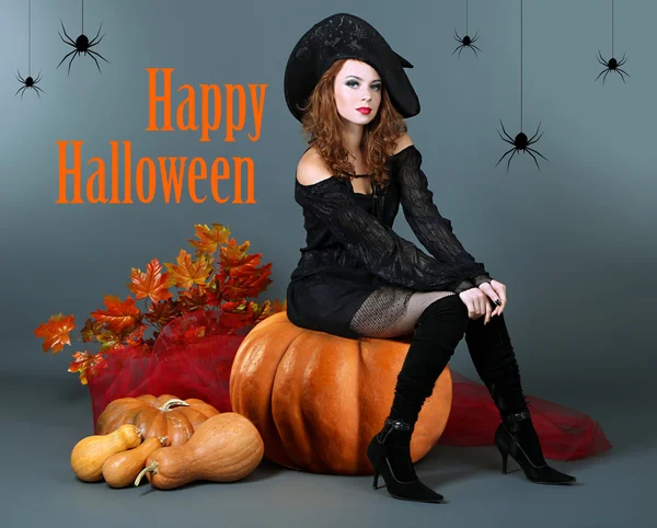 Halloween witch with broom on gray background — Stock Photo, Image