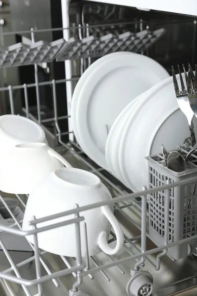 Open dishwasher with clean utensils — Stock Photo, Image