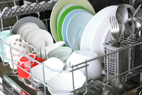 Open dishwasher with clean utensils — Stock Photo, Image