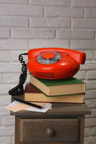 Retro phone on nightstand in room, close up — Stock Photo, Image