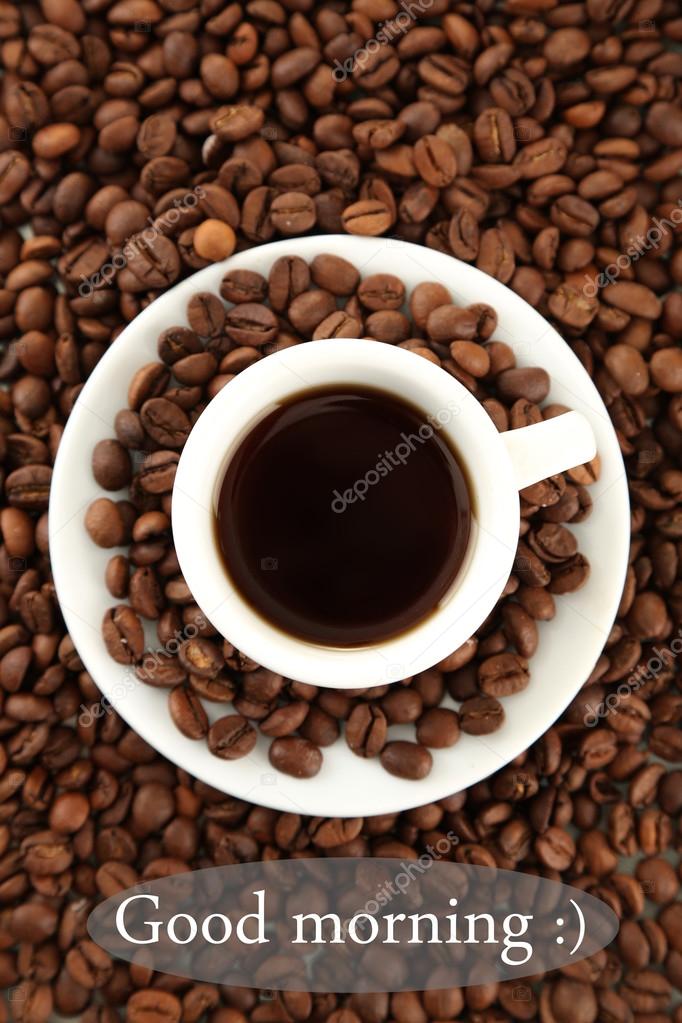 Cup of coffee on coffee beans