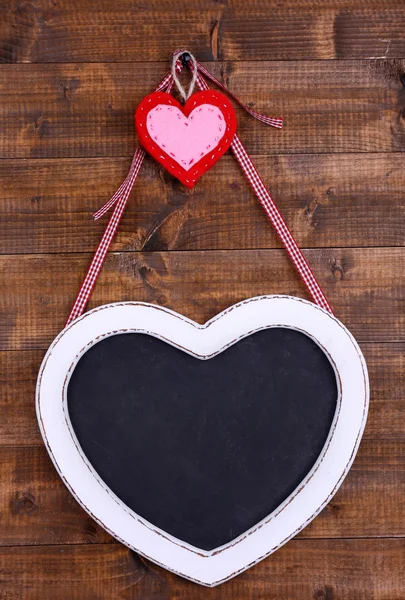 Heart shaped chalkboard on wooden background — Stock Photo, Image