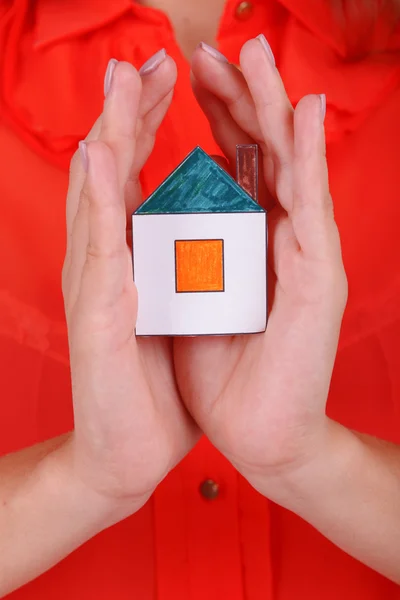 Woman hands holding small house — Stock Photo, Image