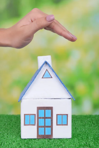 Small house with woman hand — Stock Photo, Image