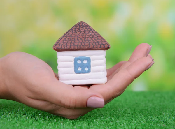 Woman hand holding small house — Stock Photo, Image