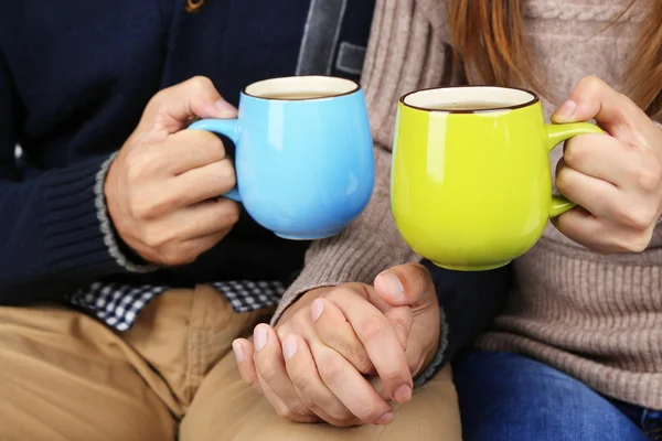 Loving couple with hot drinks — Stock Photo, Image