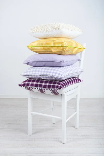 Bright pillows on chair in room — Stock Photo, Image