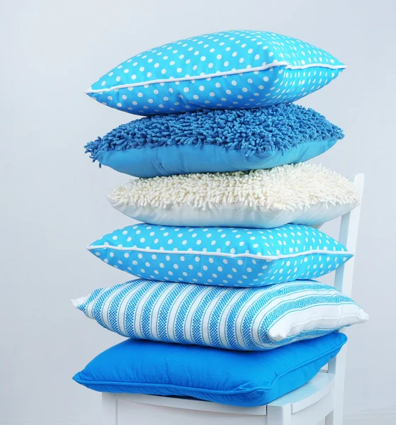 Bright pillows on chair — Stock Photo, Image