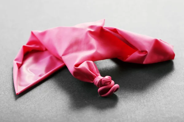 Popped pink balloon — Stock Photo, Image