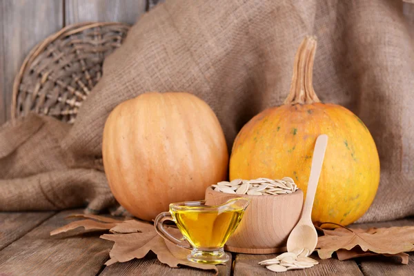 Pumpkin seeds oil in glass sauce-boat — Stock Photo, Image