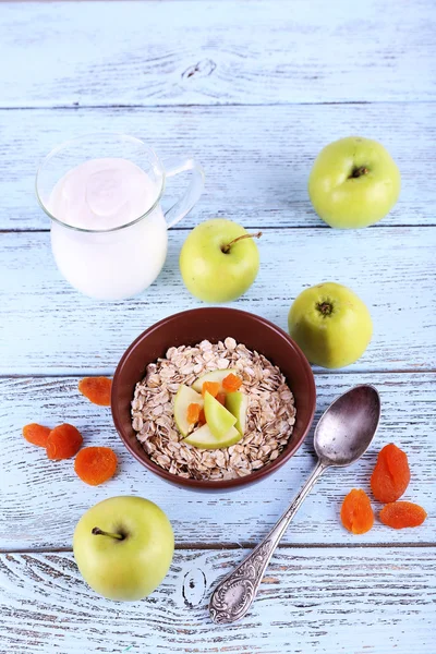 Oatmeal in bowls, yogurt, apples — Stock Photo, Image