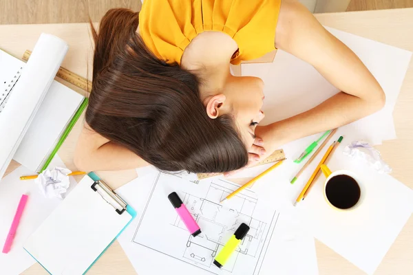 Moe meisje slaapt op tafel — Stockfoto