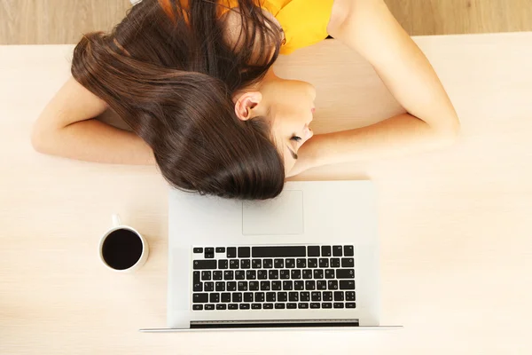 Tired girl sleeps on table — Stock Photo, Image