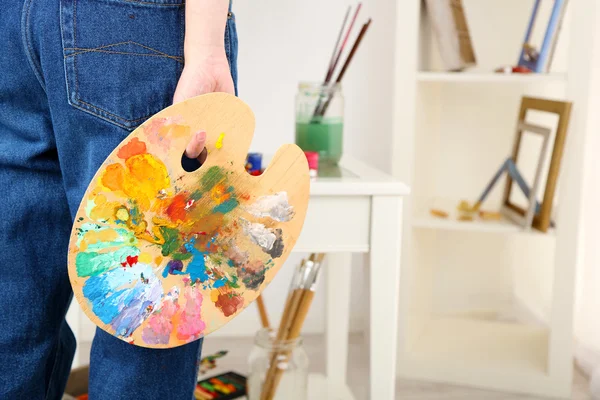Artist holding palette with paints — Stock Photo, Image