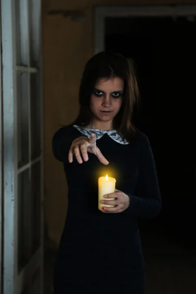 Scary woman with candle — Stock Photo, Image