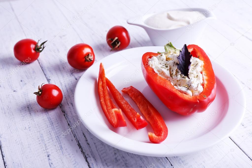 Stuffed pepper , saucer boat and tomatoes