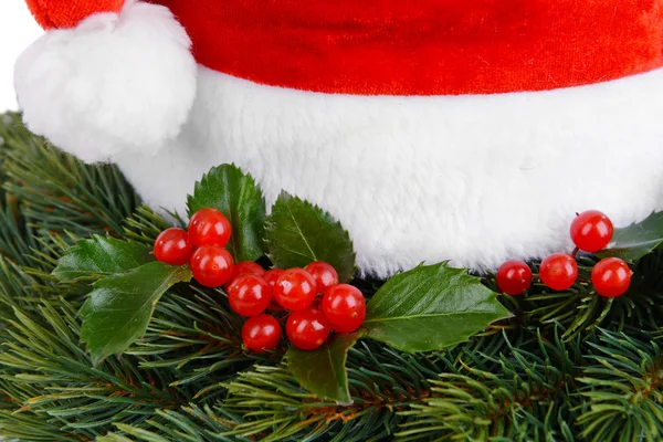 Leaves of mistletoe with Christmas hat — Stock Photo, Image