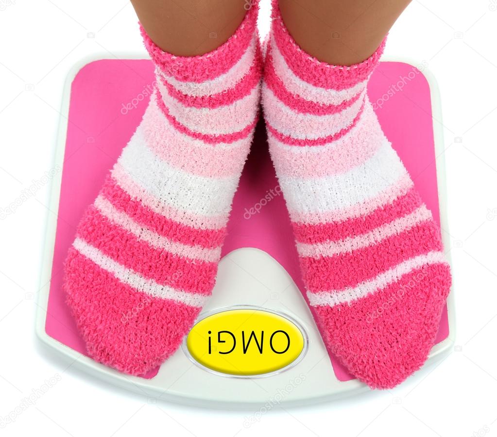 Feet in pink socks on scales