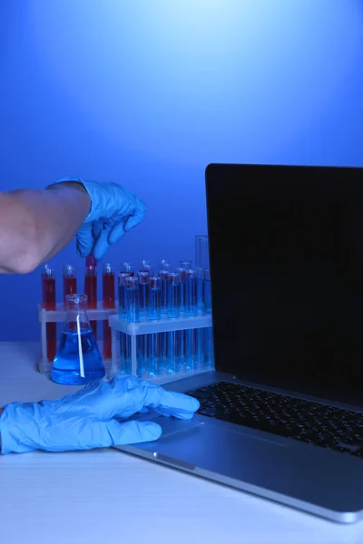 Scientist entering data on laptop computer — Stock Photo, Image