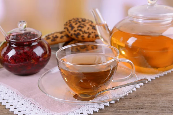 Teapot and cup of tea on table