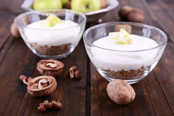 Oatmeal with yogurt in bowls, apples and walnuts — Stock Photo, Image