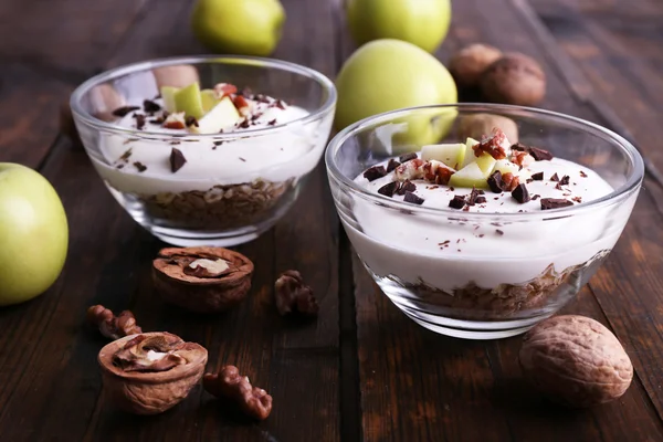 Havregrynsgröt med yoghurt i skålar, äpplen och valnötter — Stockfoto