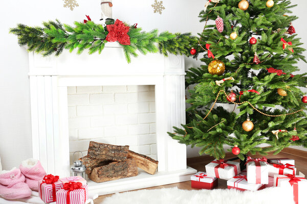 Christmas tree near fireplace