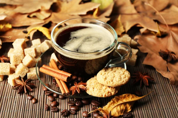 Cup of coffee, tasty cookies and autumn leaves — Stock Photo, Image