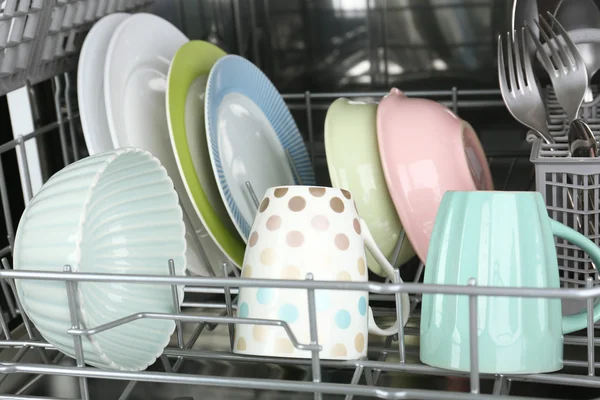 Open dishwasher with clean utensils in it — Stock Photo, Image