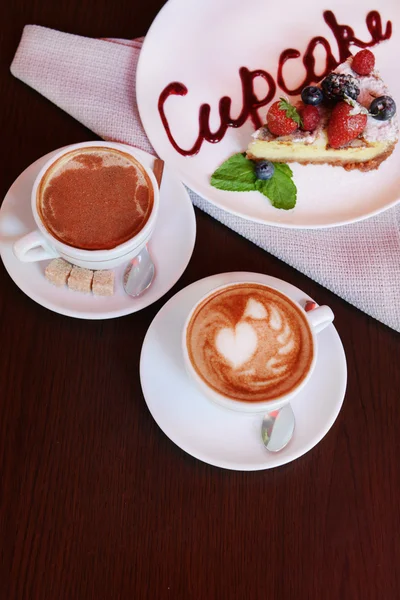 Cup of coffee with cute drawing in cafe — Stock Photo, Image