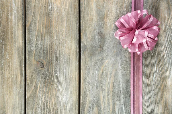 Wooden background with beautiful bow — Stock Photo, Image