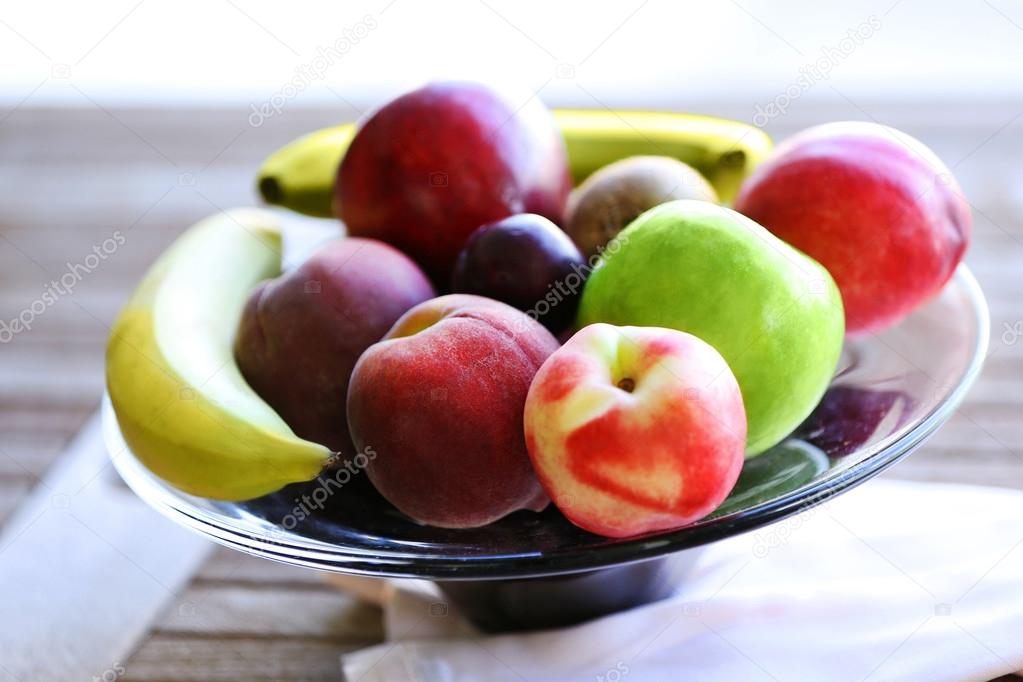 Juicy fruits on wooden table, close-up