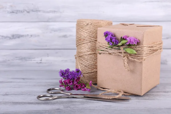 Gift with flowers and decorative rope — Stok fotoğraf