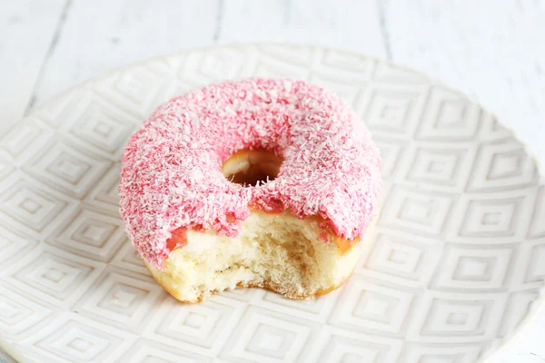 Bitten donut on table — Stock Photo, Image