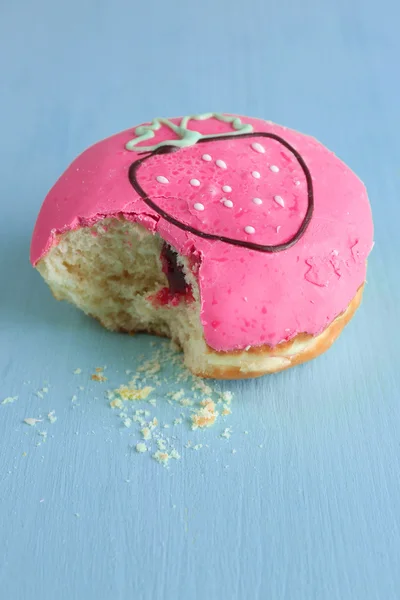 Bitten donut on table — Stock Photo, Image