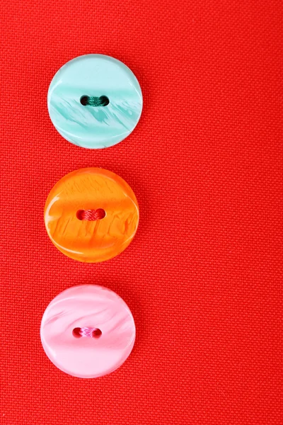 Buttons on red cloth — Stock Photo, Image