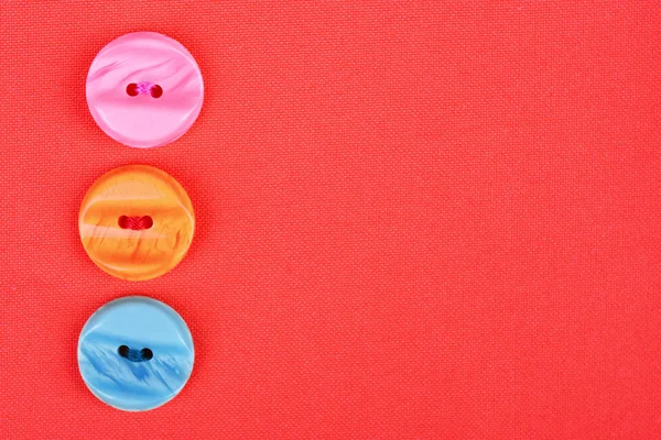 Buttons on red cloth — Stock Photo, Image