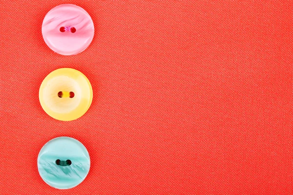 Buttons on red cloth — Stock Photo, Image