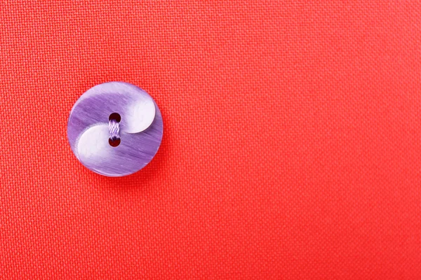 Button on red cloth — Stock Photo, Image
