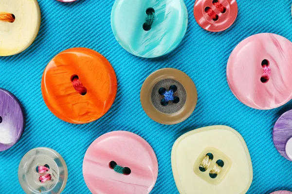 Buttons on blue cloth — Stock Photo, Image