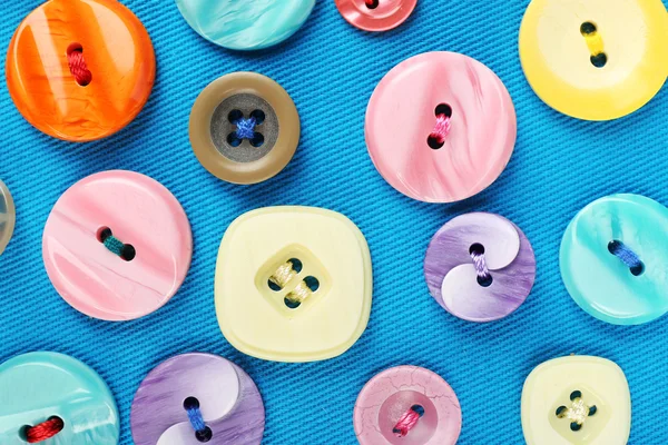 Buttons on blue cloth — Stock Photo, Image