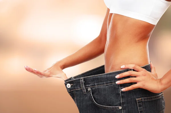 Young woman with big jeans — Stock Photo, Image