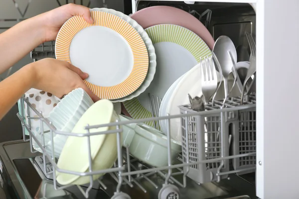 Open dishwasher with clean utensils in it — Stock Photo, Image